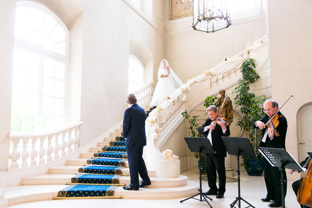 Veiled bride descends chateau staircase France