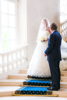 Veiled bride enters chateau wedding ceremony