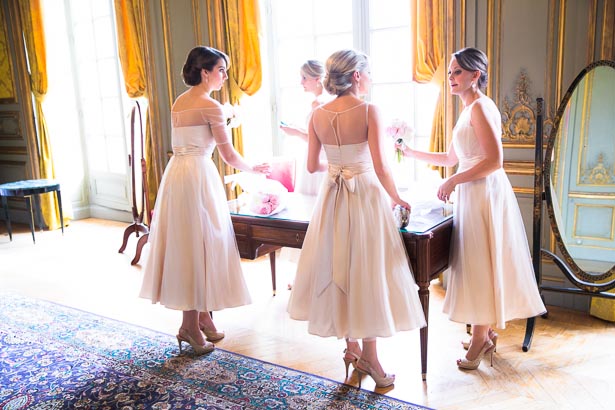 Bridesmaids by windows of French chateau