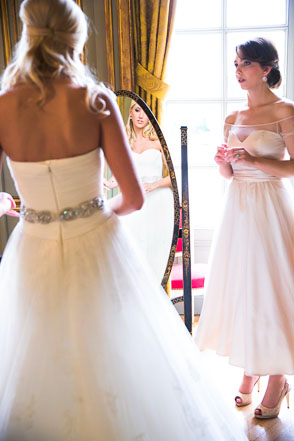 Bride looks in chateau mirror