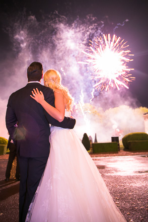 Bride and groom watch fireworks at wedding in France