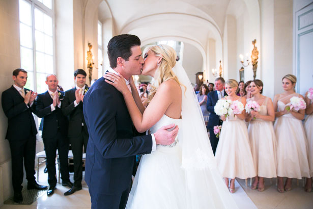 Bride and groom kiss at wedding ceremony