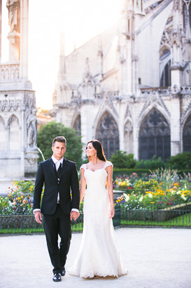 Paris sunset lights bride and groom walking hand in hand