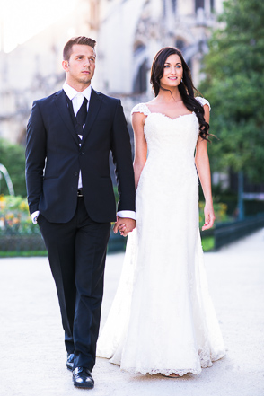 Bride walks holding hands with groom in Notre Dame garden