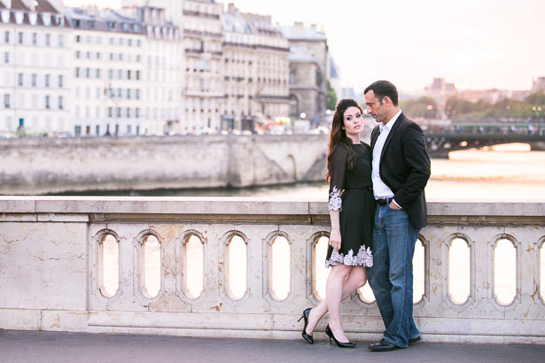 Engaged couple in front of Paris skyline
