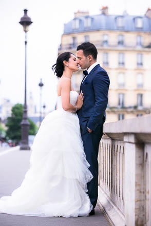 Bride Kissing Groom in Front of Beautiful Paris Building