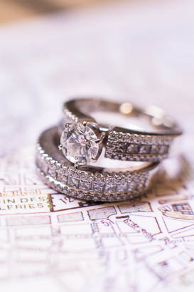 Wedding and Engagement Rings Lying on Paris Map