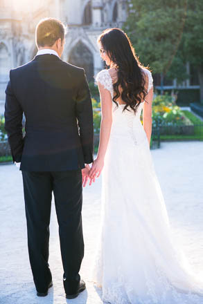 Back of Wedding Gown as Bride Holds Hands with Groom