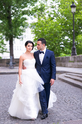 Bride and Groom Walk Along Cobblestone Street in Paris