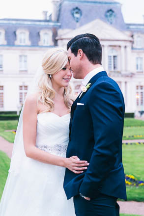 Groom and Bride Embrace in Front of French Chateau