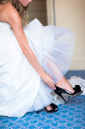Bride Putting on Black Wedding Shoes