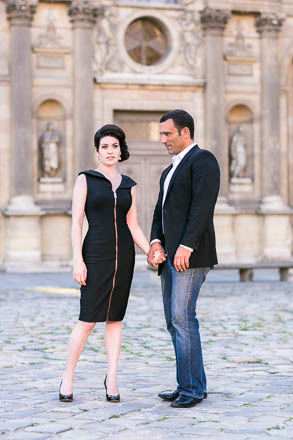Couple Holding Hands in Louvre Courtyard