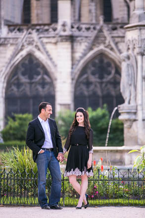 Gothic Arches of Notre Dame Behind Engaged Couple