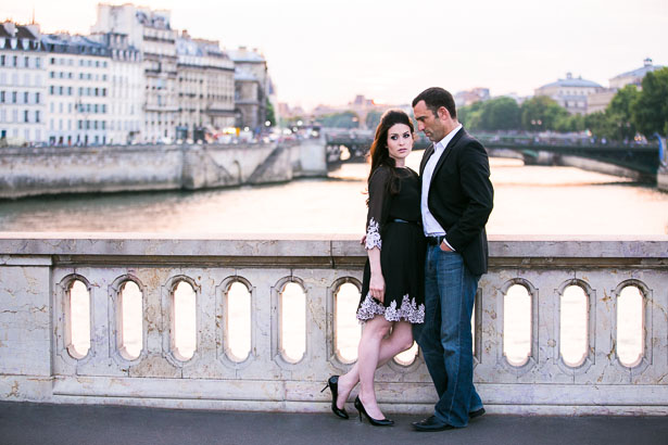 Romantic Couple Standing on Paris Bridge at Sunset