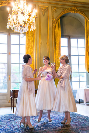 Laughing Bridesmaids Under a Chandelier