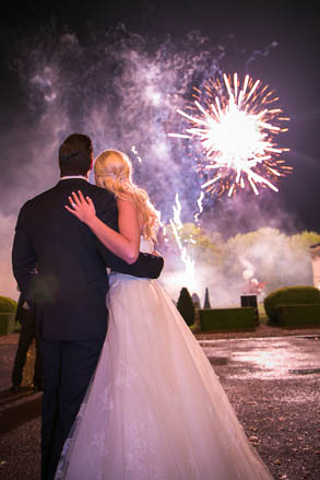 Bride and Groom Watching Fireworks Over a Chateau Garden