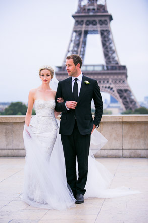 Bride and Groom Walking Arm in Arm Near Eiffel Tower