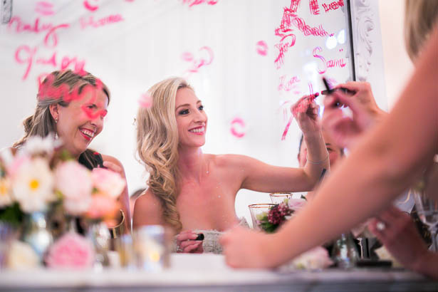 Bride Writing Lipstick Message on Mirror